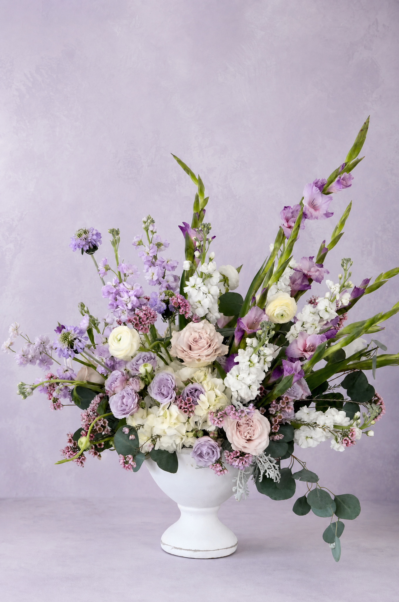 A MoonBloom arrangement — lavender stock, garden roses, gladiolus, and ranunculus
